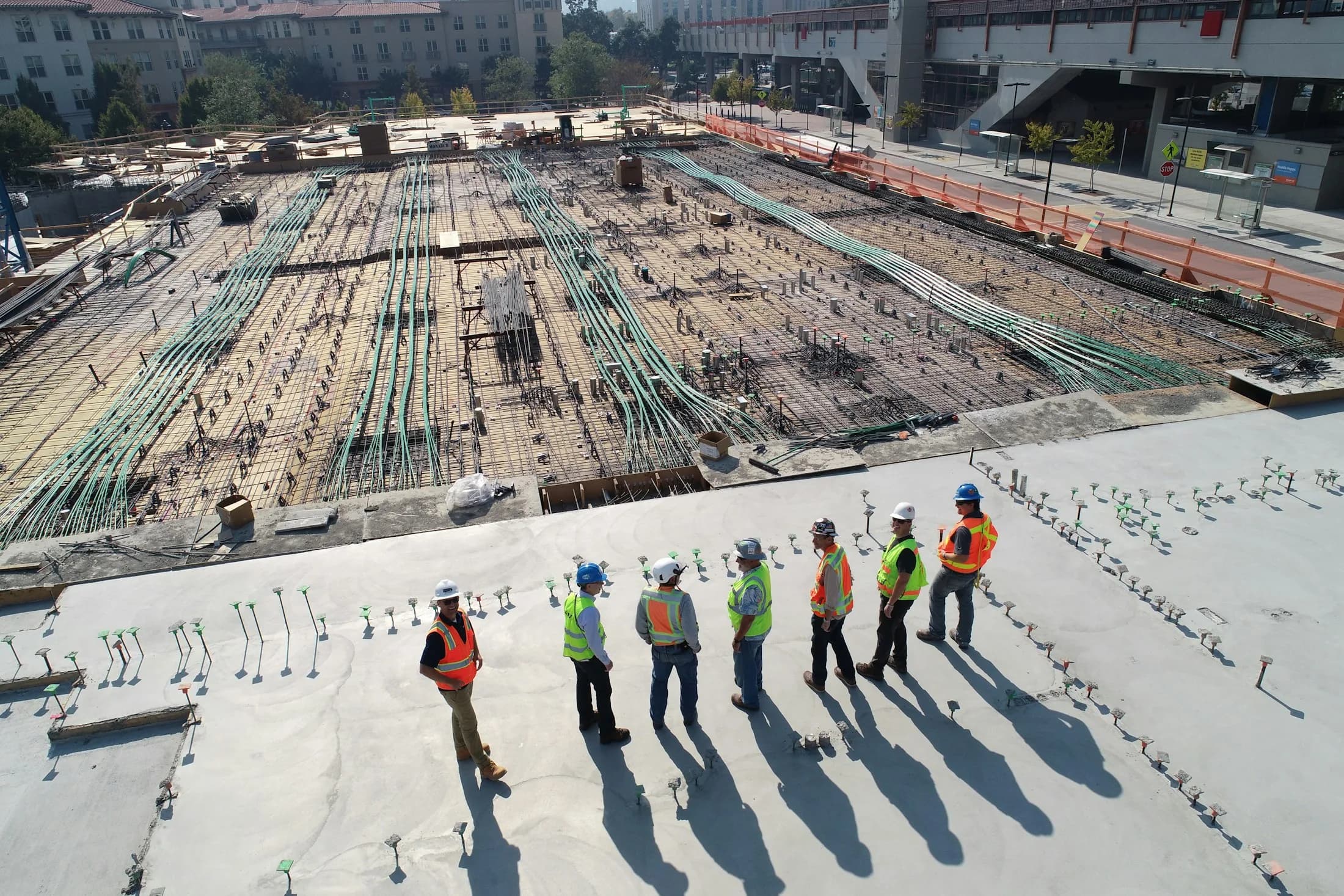 Aerial view of a large construction site with workers and formwork