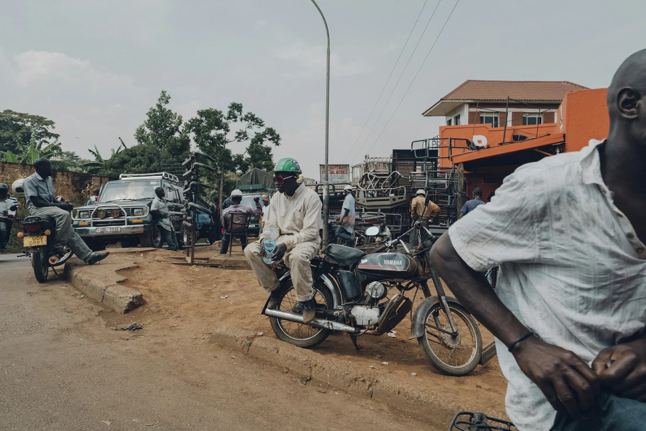 Boda-boda riders waiting on a Kampala street