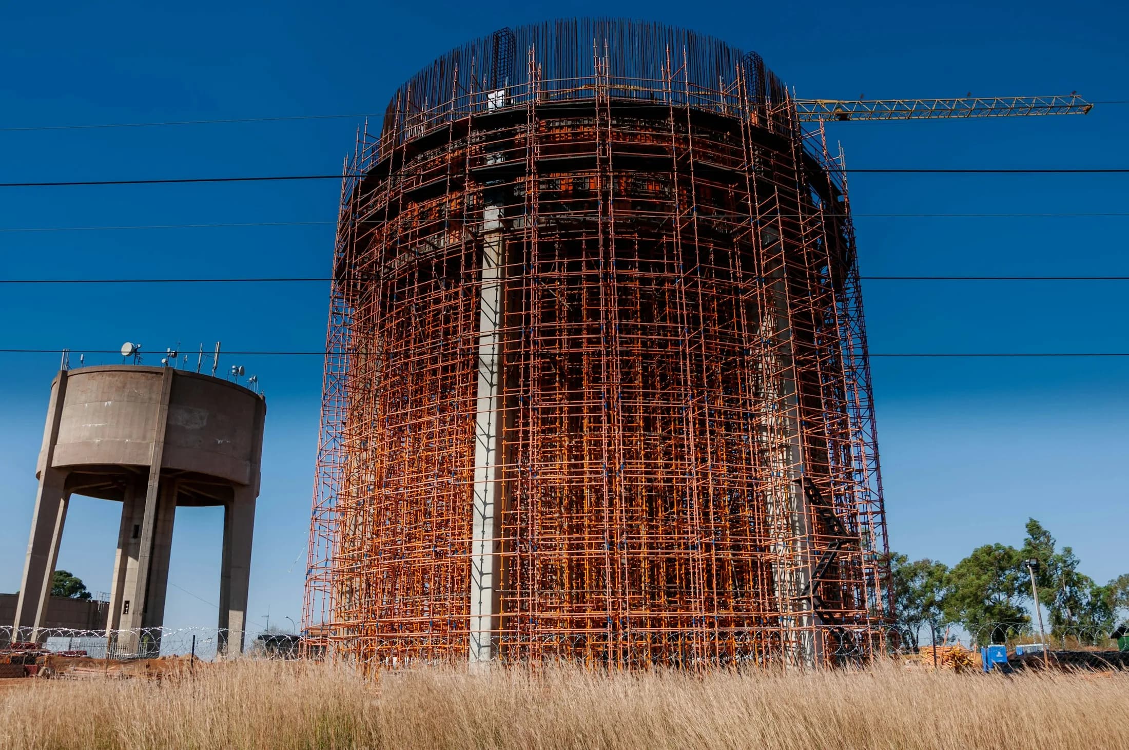 A large water tower under construction with scaffolding
