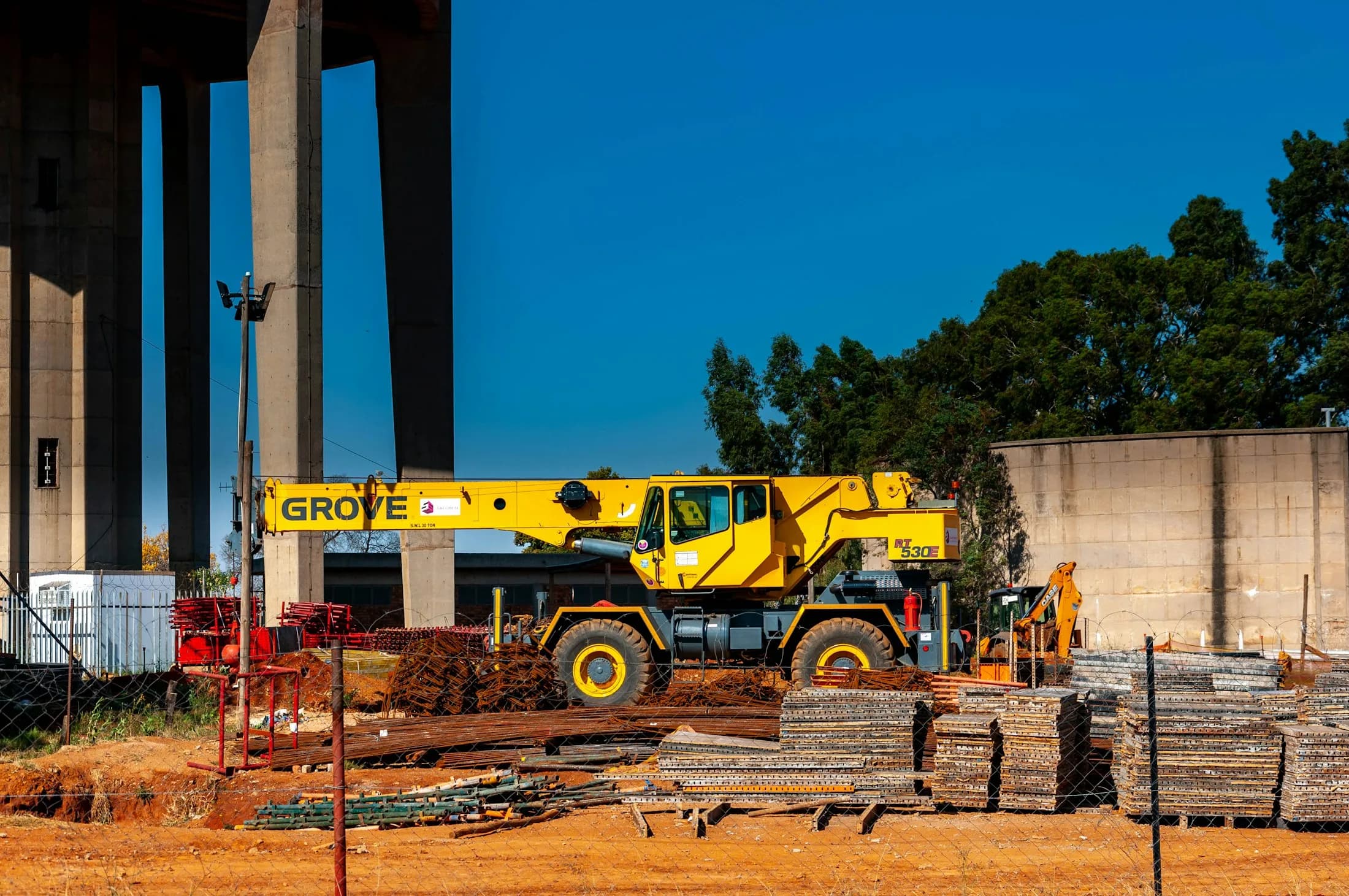 Crane and excavator working on a large industrial site
